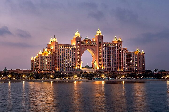 Experience the grandeur of Dubai with magnificent architecture shimmering against the night sky. Discover the luxurious lifestyle and unique culture during your unforgettable stay in this stunning city.
